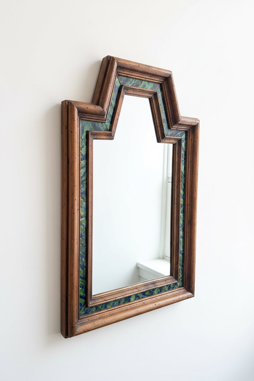 Vintage wood-framed wall mirror featuring decorative inset panels